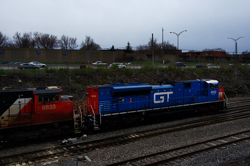 Going away view by Michael Berry Railfan, The GT heritage unit leads CN 527 on a dreary afternoon. Soon the train will enter Taschereau Yard w