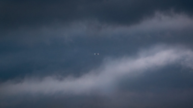 Small airplane in front of threatening thunderstorm