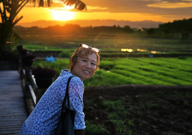 Kanitha admires the enchanting sunset over the rice fields