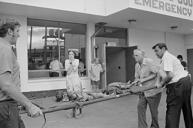 War orphans being taken into the hospital emergency entrance in Saigon, 4 Apr 1975.