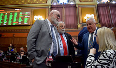 State Rep. Ben McGorty discusses important public safety legislation with colleagues before a final vote tally.