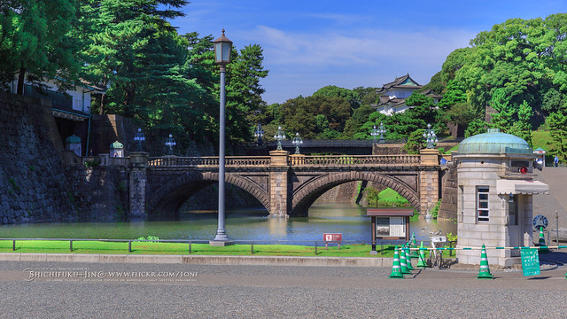 tokyo imperial palace, stone bridge, trees, green, blue sky,  no people, no hdr, no presets,  moats and massive stone walls in the center of Tokyo