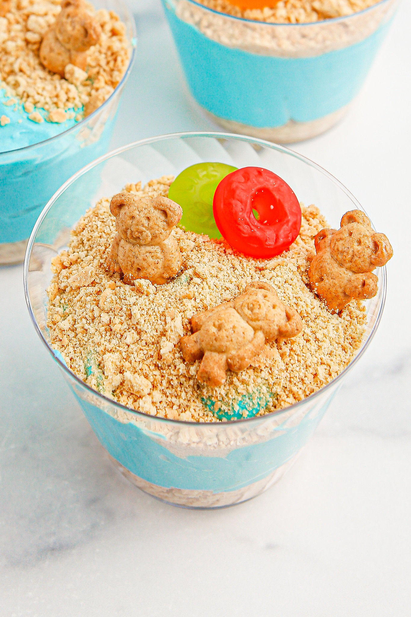 3 Teddy Grahams on top of a pudding cup with graham cracker crumbs
