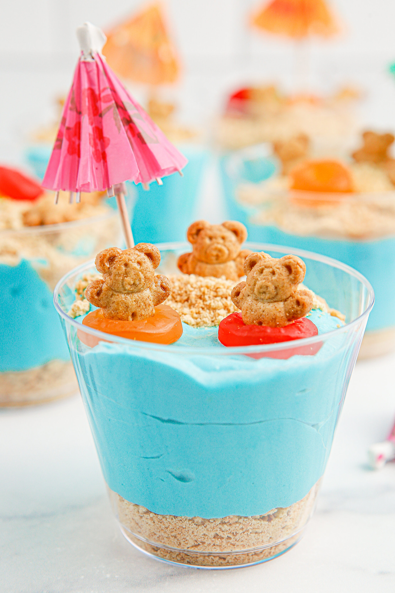 The cutest summer dessest! Beach Bear Pudding Cups have layers of crushed graham crackers and pudding, topped with gummy candy and Teddy Grahams. 
