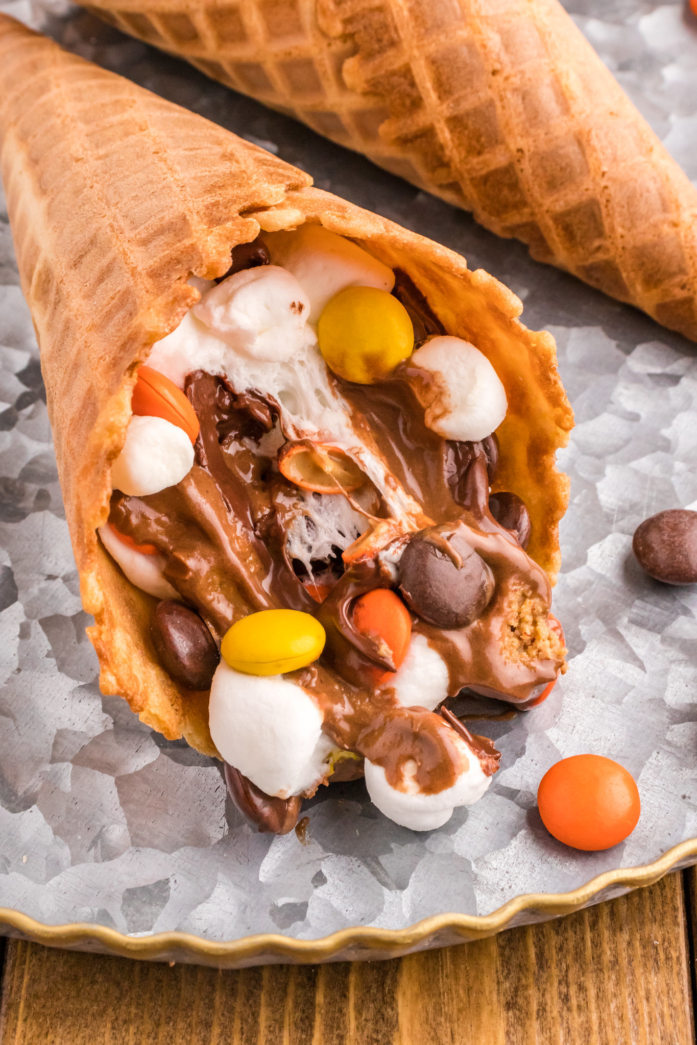 Waffle cone with melted chocolate, marshmallow, reese's pieces, and mini peanut butter cups. 
