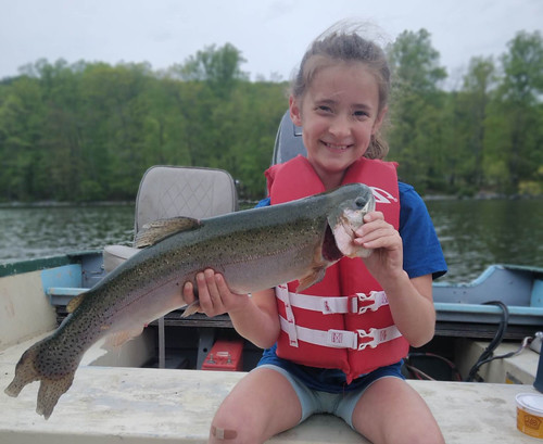 Photo of girl holding a rainbow trout