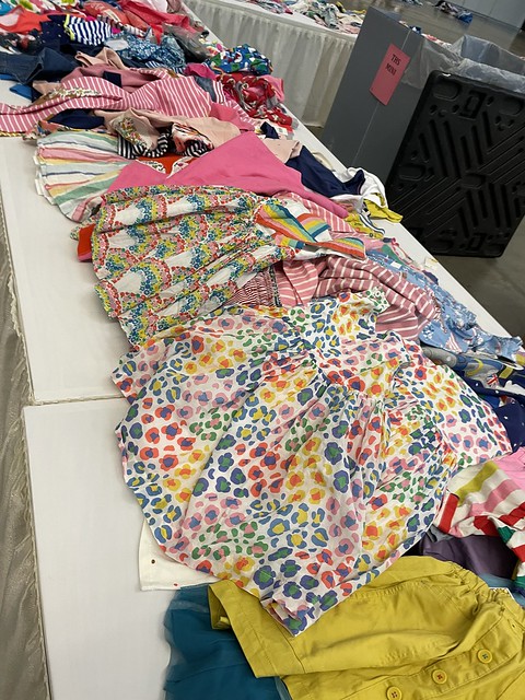 Photo of Mini Boden Sample Sale Table with colorful clothes
