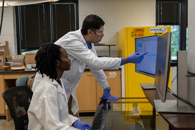 Ahmed Hamid in his lab with graduate student Benedicta Donkor