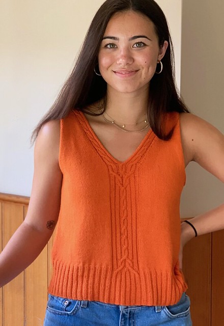 Della Mae Tank by Angela Hahn is summer-ready, both to knit and to wear! With beautiful front & back V necks and centered flowing cables, this piece has a flattering fit and is stylishly comfortable.