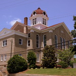 Jackson County Courthouse - Jefferson, GA From Wikipedia:
Jackson County Courthouse is a two-story brick building designed by architect W.W. Thomas and built in 1879 in Jefferson, Georgia. Its Classical Revival clock tower was added in 1906. It was one of the first post-Civil War county courthouses built in Georgia. It is unusual for surviving little-altered since construction. In 2004, a new courthouse was built in Jefferson.  It was renovated in 1978.

Its courtroom has a &amp;quot;Cathedral quilt&amp;quot; pressed metal coved ceiling and egg and dart cornices.

Its architect, William Winstead Thomas (1848-1904), was president of an insurance company but also designed buildings, including the White Hall estate house outside Atlanta and at least two other courthouses.

It was listed on the National Register of Historic Places in 1980.
