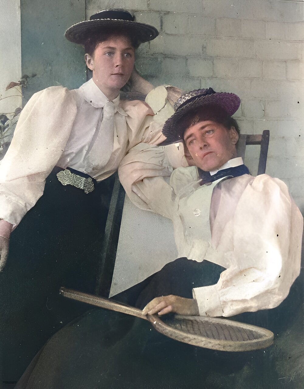 Two women dressed for a game of tennis, 1890-1900