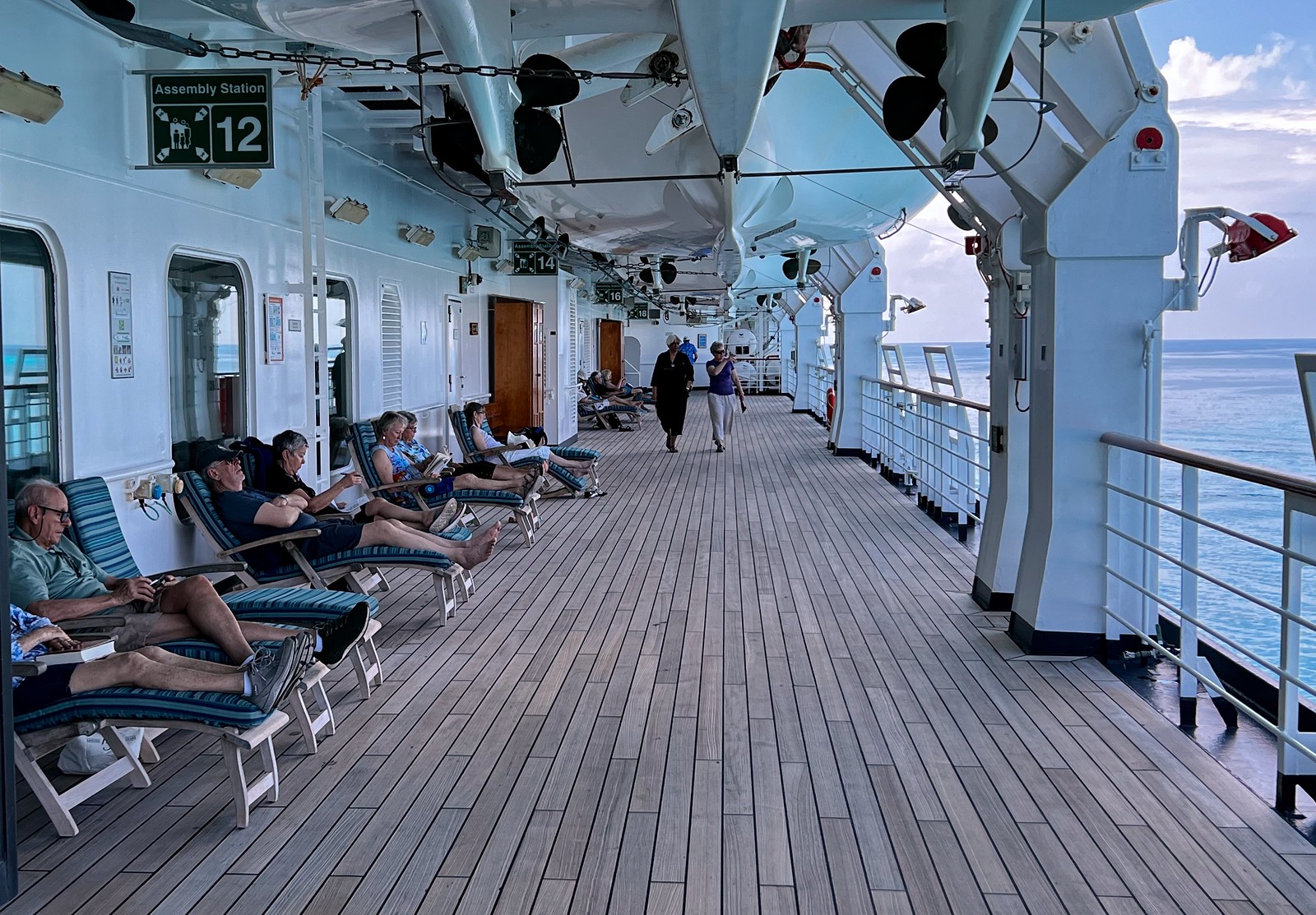 Passengers enjoying the shady side of the Promenade Deck
