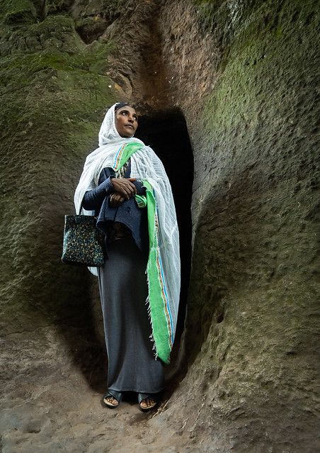 Ethiopian woman pilgrim in a rock-hewn church, Amhara Region, Lalibela, Ethiopia