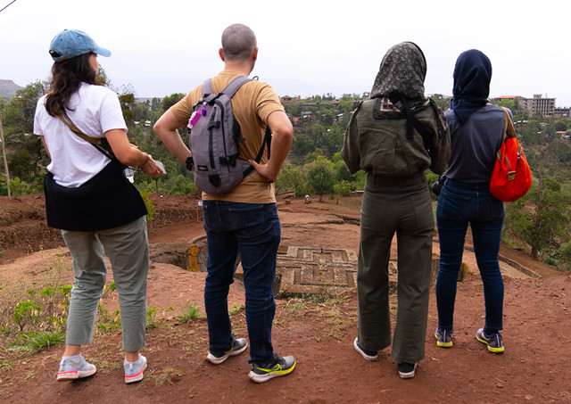 Tourists looking at Saint George rock-hewn church, Amhara Region, Lalibela, Ethiopia