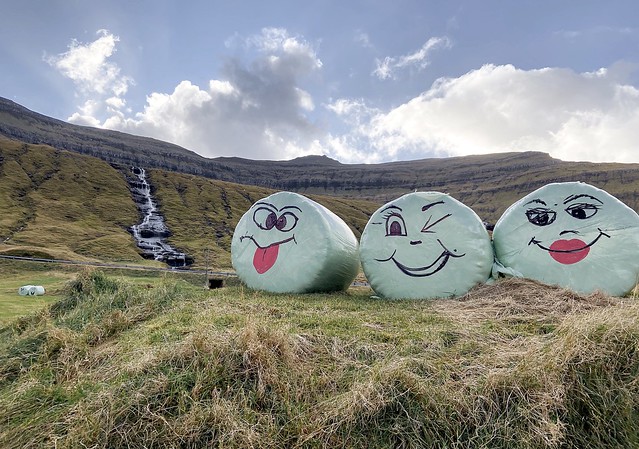 Waterfall and funny bales of straw near Hósvík, Streymoy, Faroe Islands.