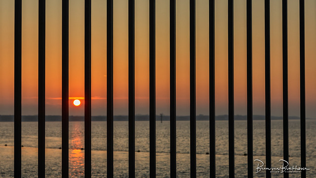 Sunset behind bars