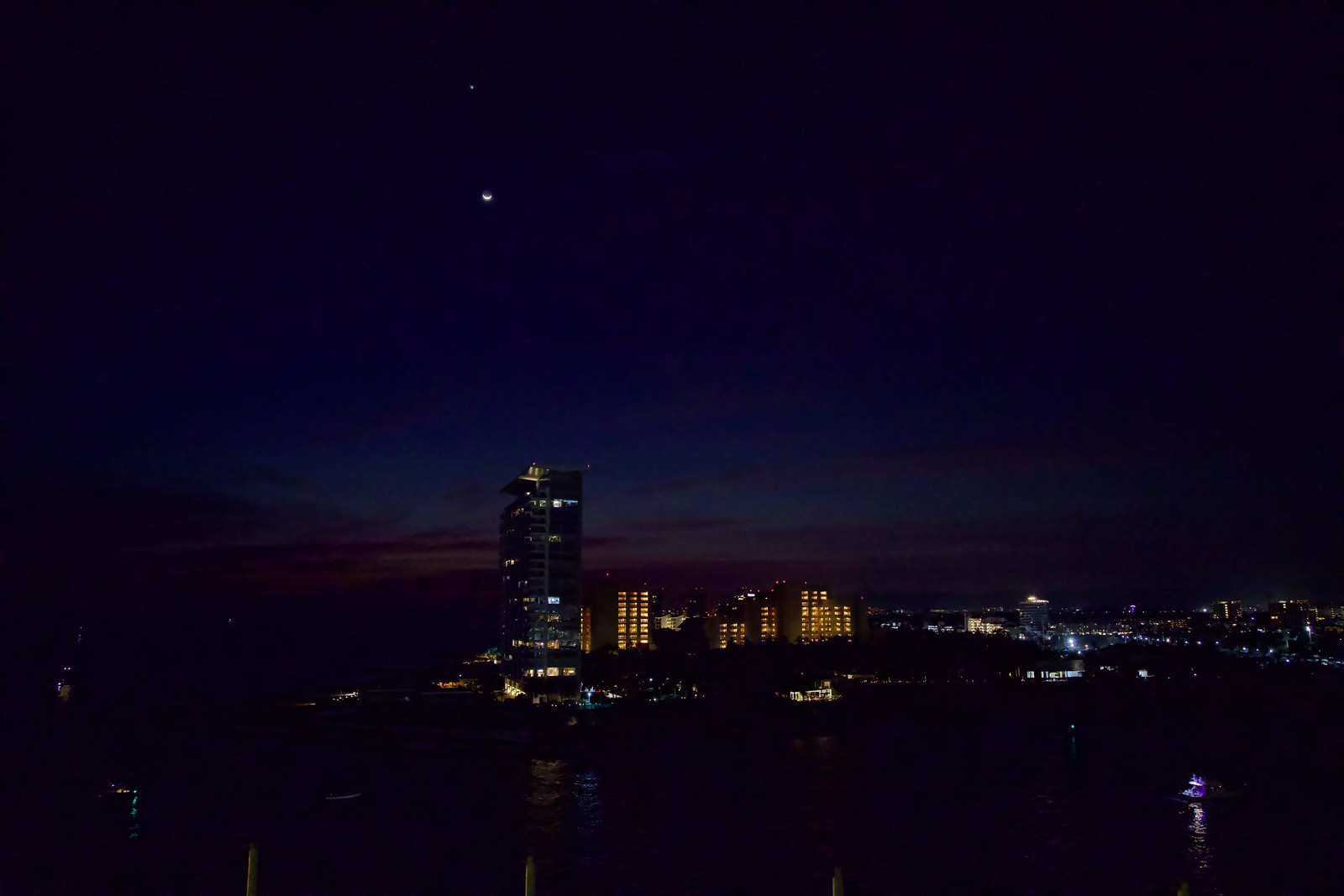 Crescent Moon and Venus above the harbour and the highrises