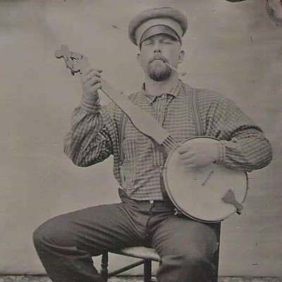 photo of man playing the banjo