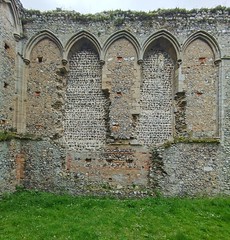 arcading in the chancel with two blocked windows and the setting for the piscina and sedilia below