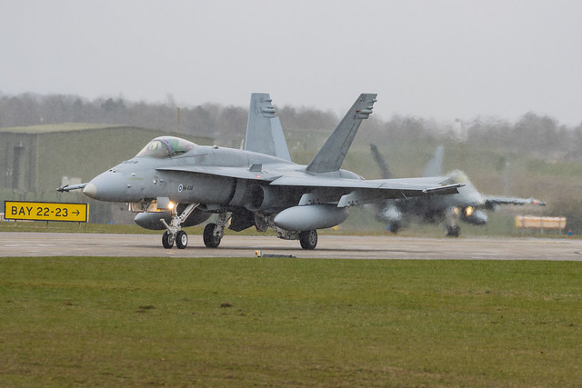 Finnish Air Force | HN-438 F/A-18C Hornet | LYNX flight taxies out during a brief snow shower