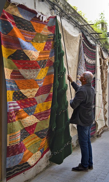 Morocco_Tangier_RaisingcolorfulCarpet