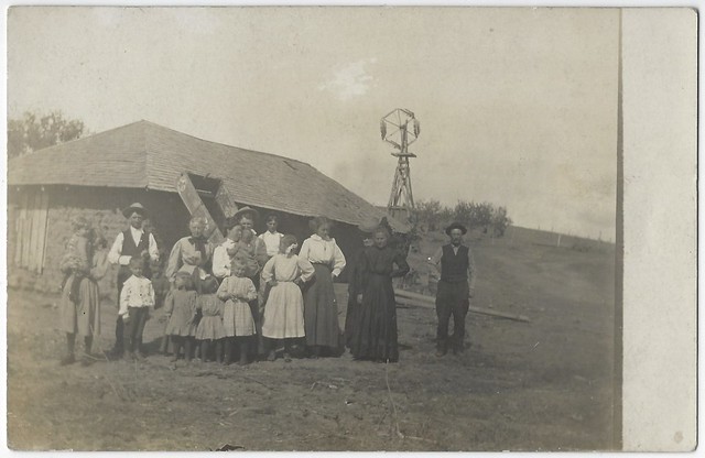Group Posed In Front Of Sod House. RPPC.