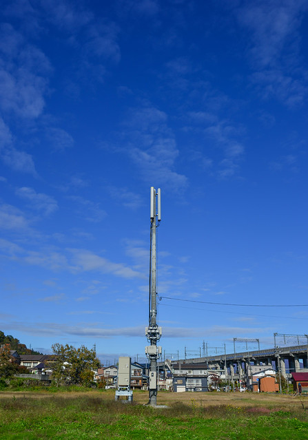 Telecommunications tower under a blue sky