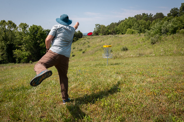 photo of people playing disc golf