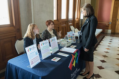 State Rep. Tracy Marra talks with Emily Perron, community engagement manager, and Amanda Redfern, young adult housing navigator, for Triangle Community Center in Norwalk, during Pride Day at the Capitol.