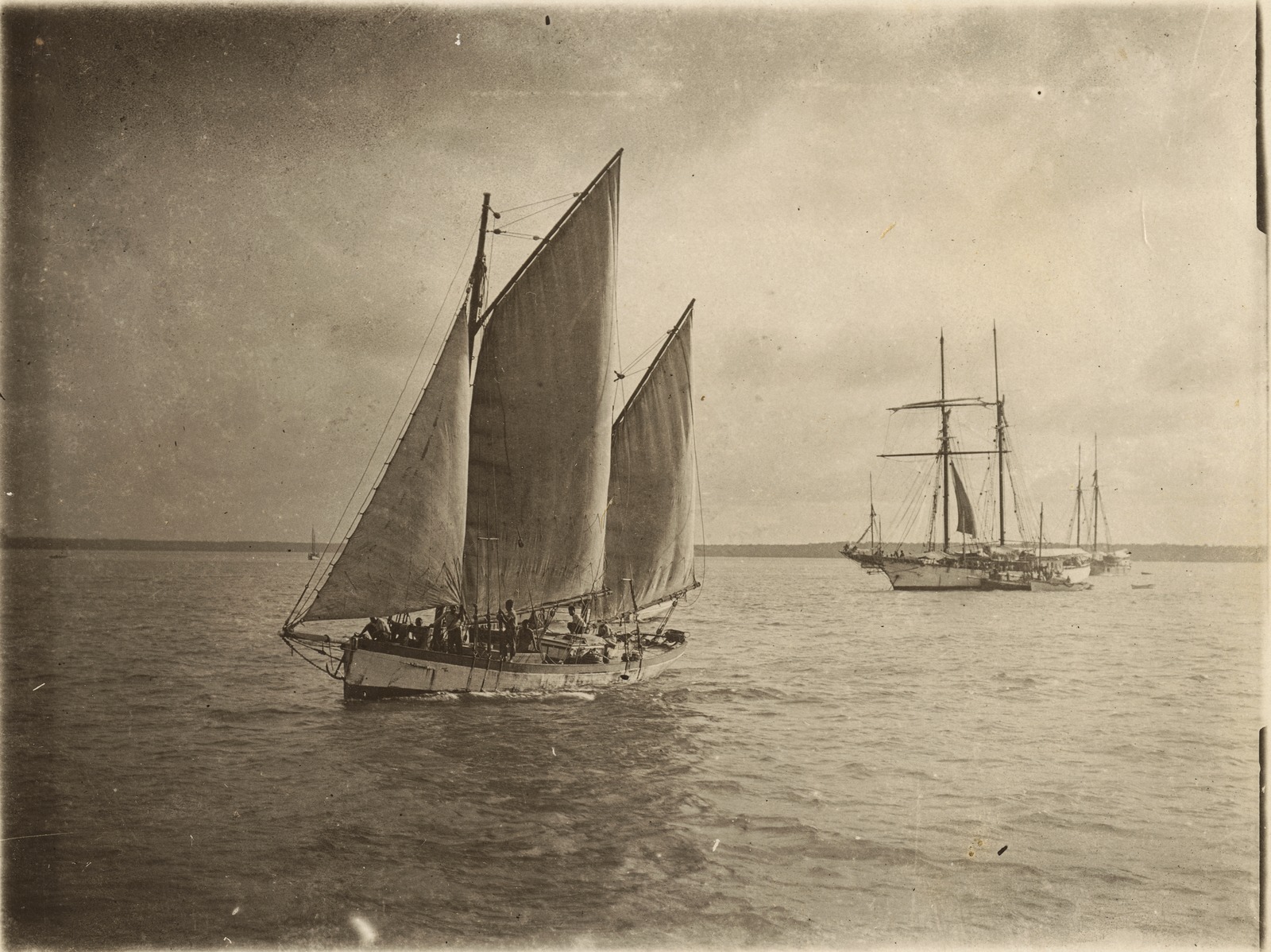 Sails unfurled on a Torres boat with a topsail schooner at anchor, Aru Islands Regency, 1908