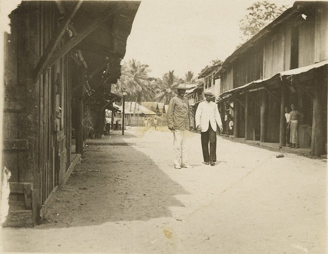 Two men standing in the middle of the street in Dobo, Warmar Island, 1908