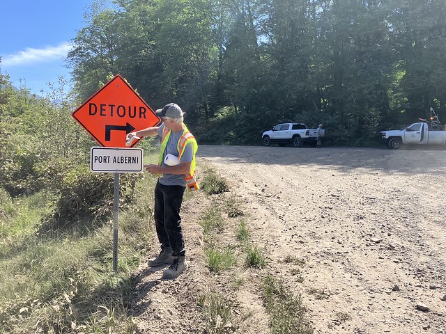 BC Highway 4 - Cameron Lake Bluffs Wildfire-Worker maintaining detour signage