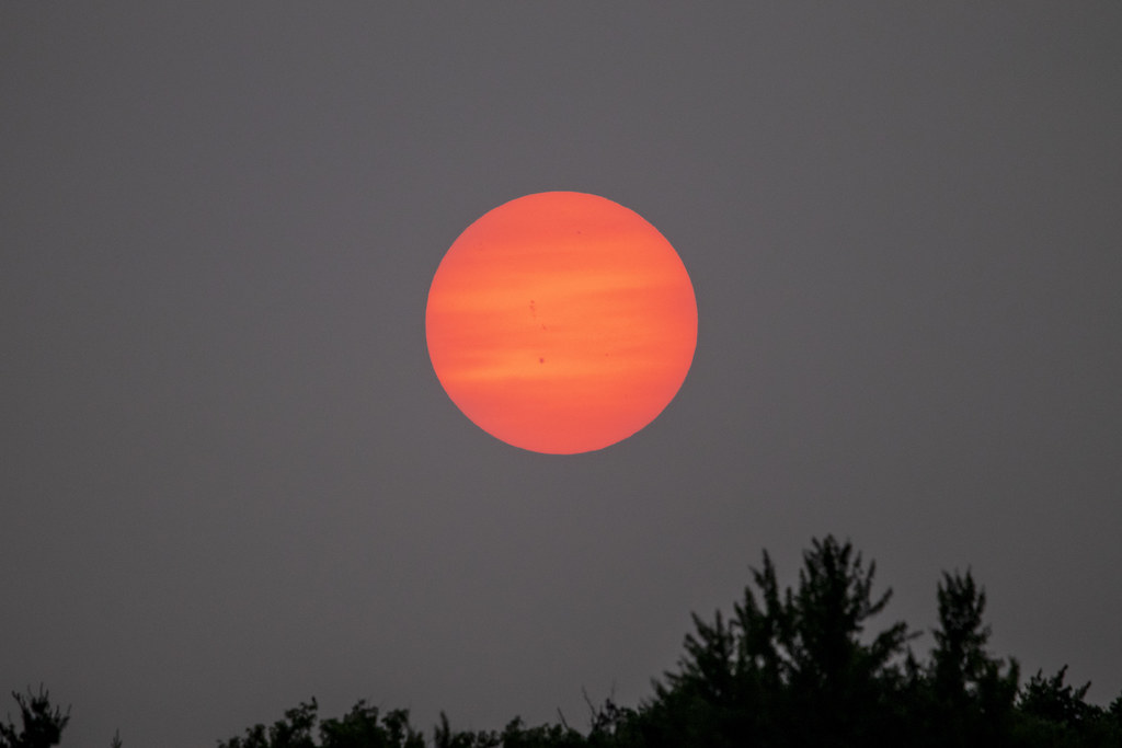 red sun setting as the wildfire smoke arrives into DC, from the top of Fort Reno