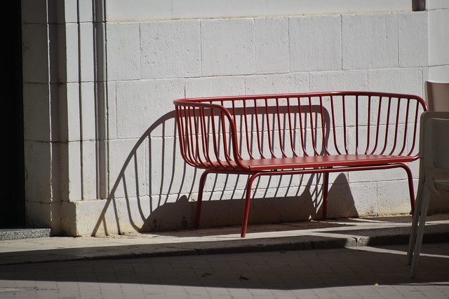 red bench and its shadow