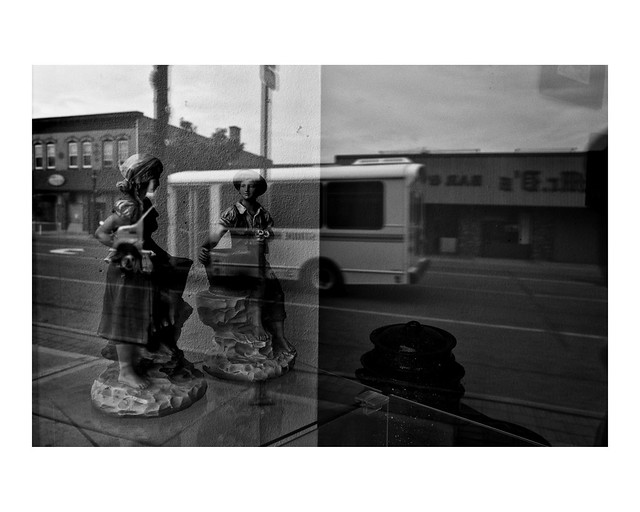 Kitschy figurines in vacant storefront window