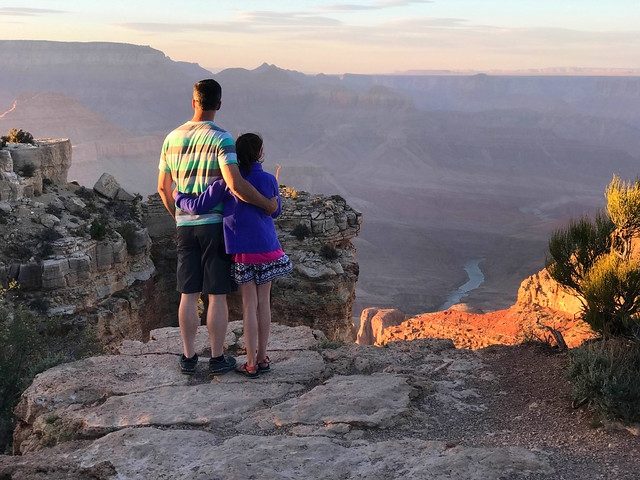 Father and Daughter looking at the Grand Canyon and Colorado River at Moran Point, Arizona