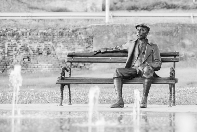 Man on bench sculpture
