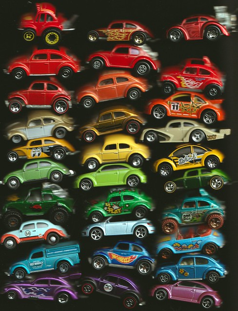 Thirty Volkswagen Beetle diecast cars on a scanner bed.