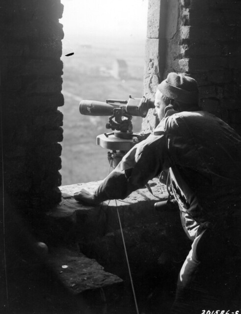 SC 201586-S - Pvt. Robert E. Hammond, Osceola Mills, Pa., directs artillery fire on Modrath, Germany, in support of an infantry regiment's drive to take the town.
