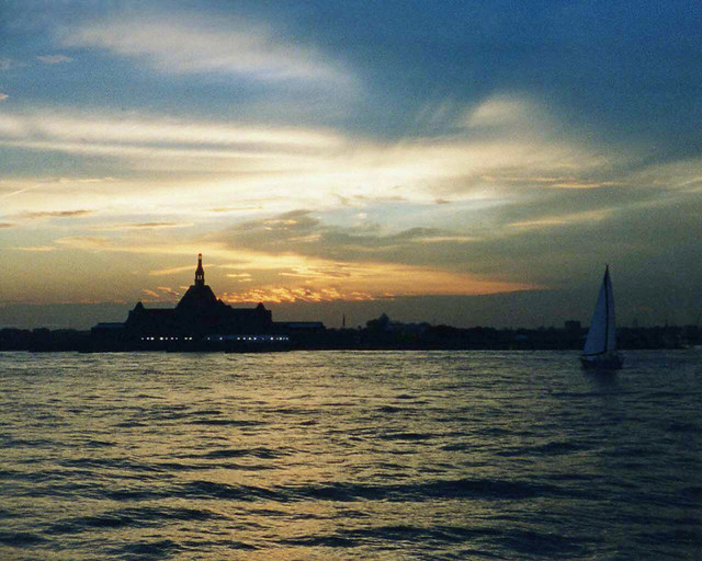 Coming home on the Staten Island Ferry, I noticed the sunset over the old Central Railroad of New Jersey Terminal. In the golden waves was also a sailboat plying the sunset waters. It was simply beautiful! Jersey City. Sept 2005