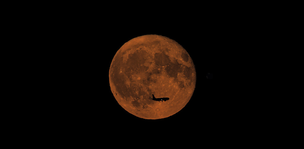 Tonight's full moon with a flyby Boeing.