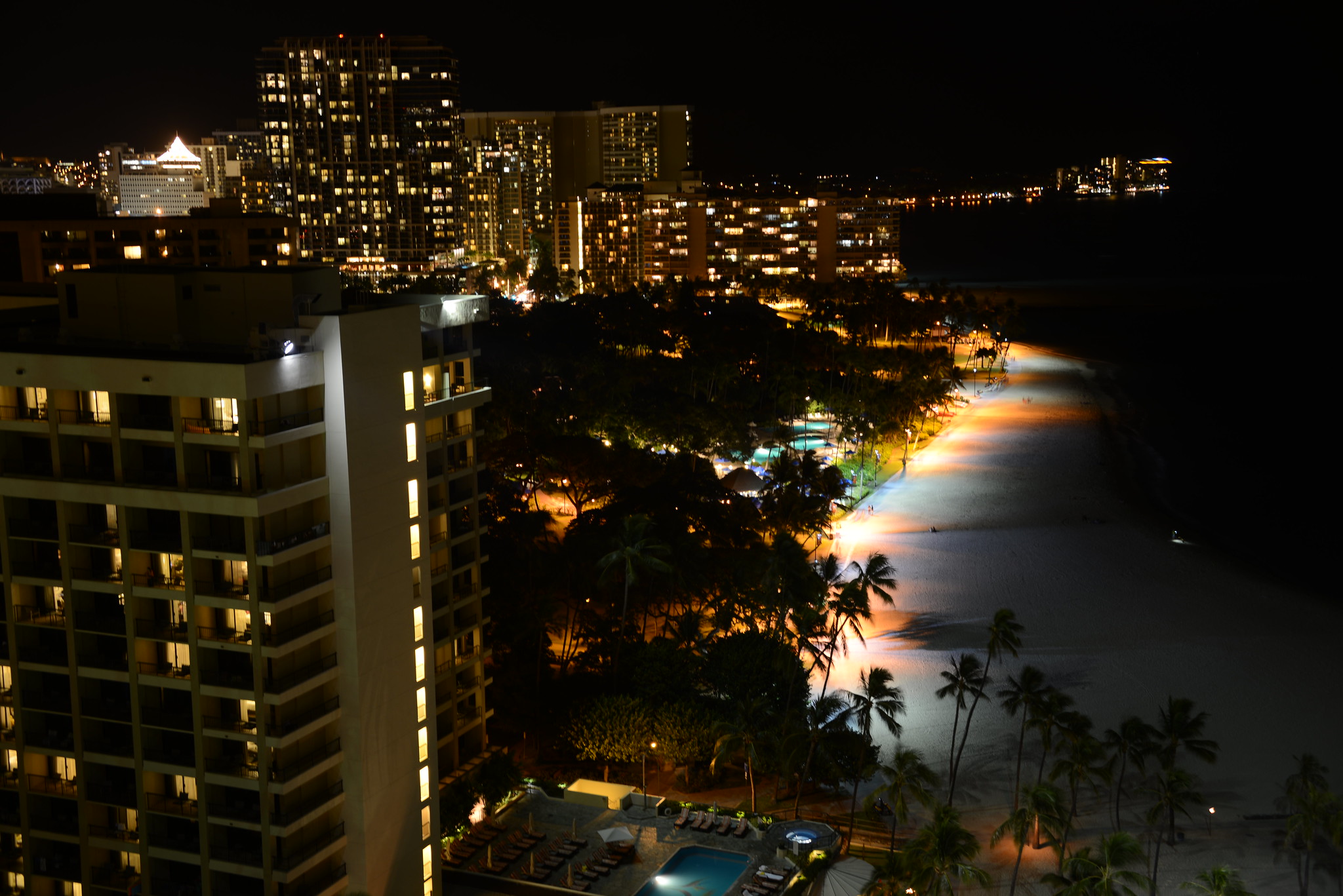 A view of the beach at night in Waikiki