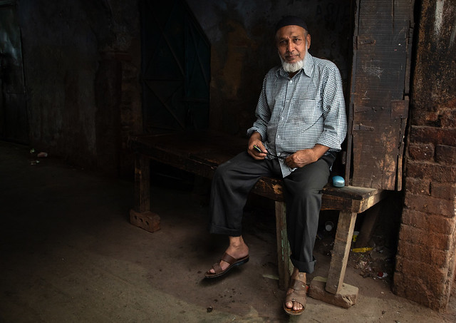 Portrait of an indian man sit at the entrance of his house, Delhi, New Delhi, India