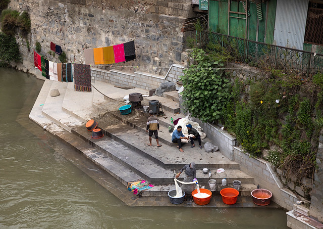 Men washing clothes on the ghat of Jhelum River, Jammu and Kashmir, Srinagar, India
