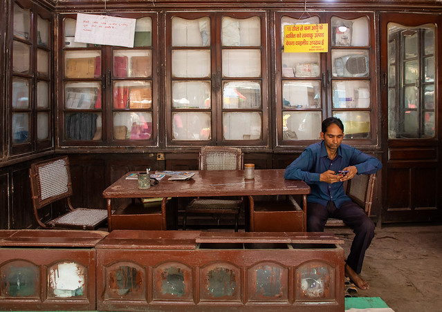 Indian man sit in his shop in old Delhi, Delhi, New Delhi, India
