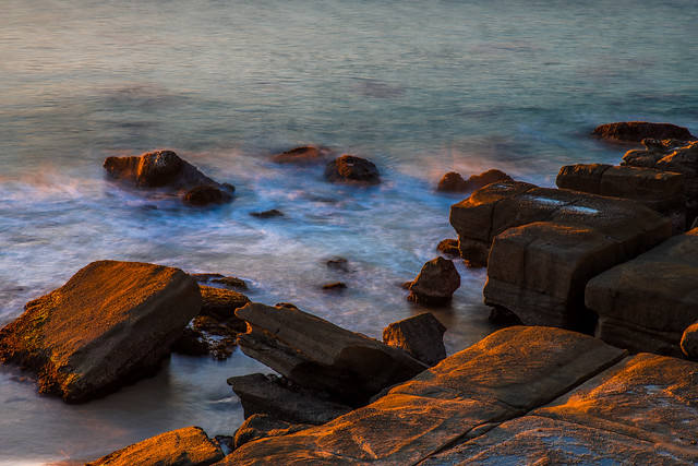 Rocks and the sea in the early morning sunlight