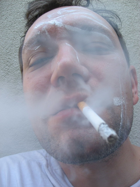 Selfie of a drunk me smoking tobacco at my studios little balcony outside very smoky