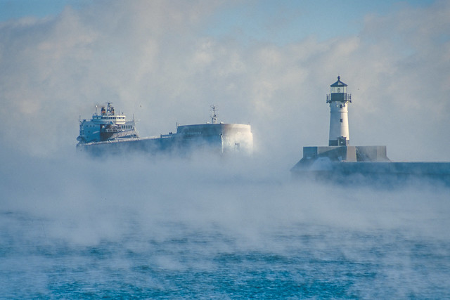 Paul R. Tregurtha, the largest ship to sail the Great Lakes, emerges from the fog and approaches the entrance to the Port of Duluth, Minnesota, three days before Christmas in 1998.