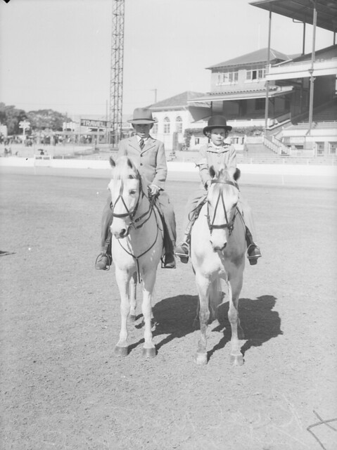 Boy and girl riding their ponies at the Royal National Show, Brisbane, 1948