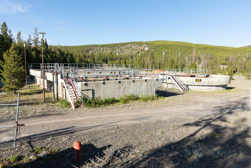 Large, unused concrete structures in a dirt lot.